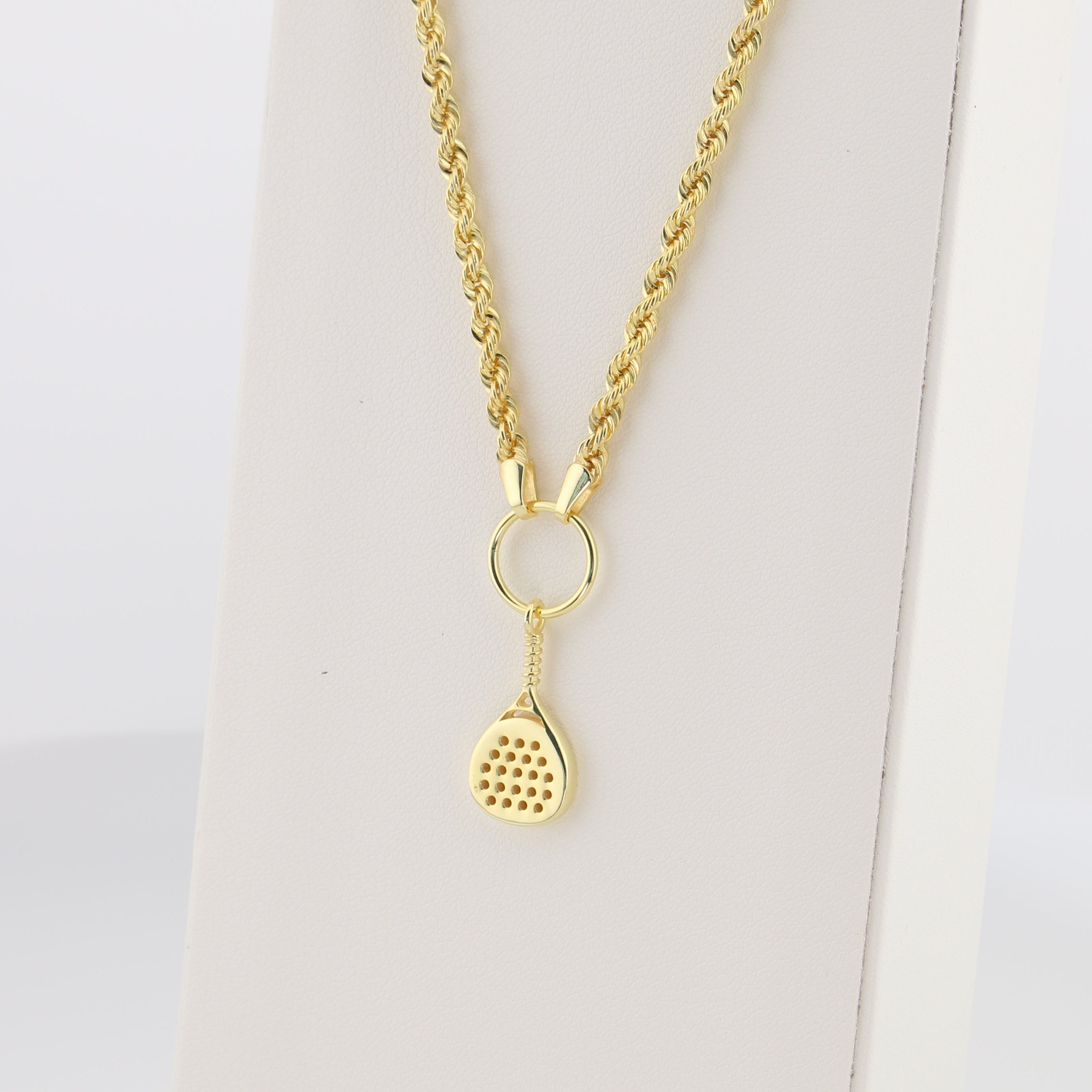 Gold necklace with a padel racket pendant on a white background